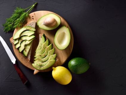 Avocado slices on wooden plate